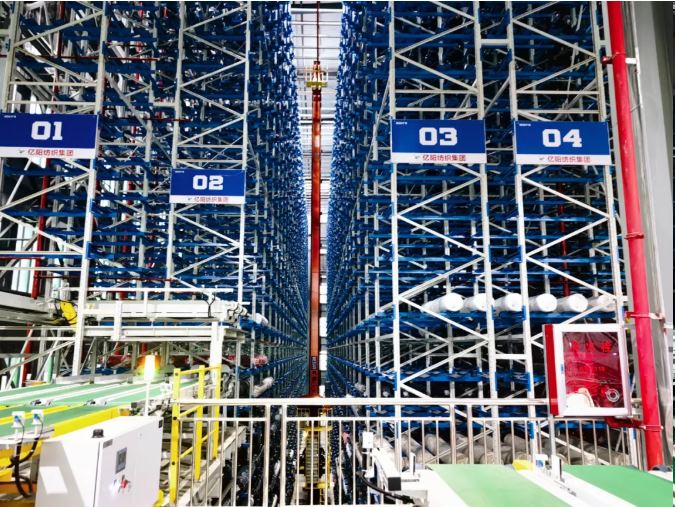 Automated conveyor line and RGV interface feeding the stacker cranes